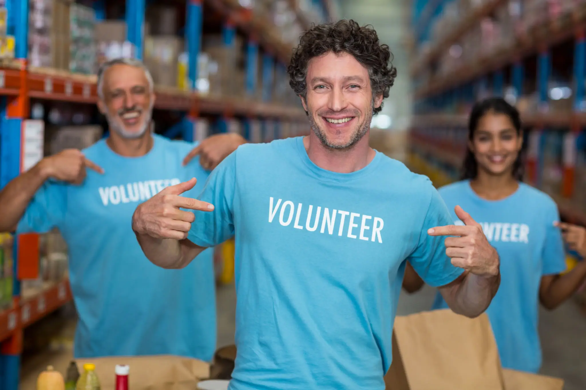 Smiling volunteers in a warehouse