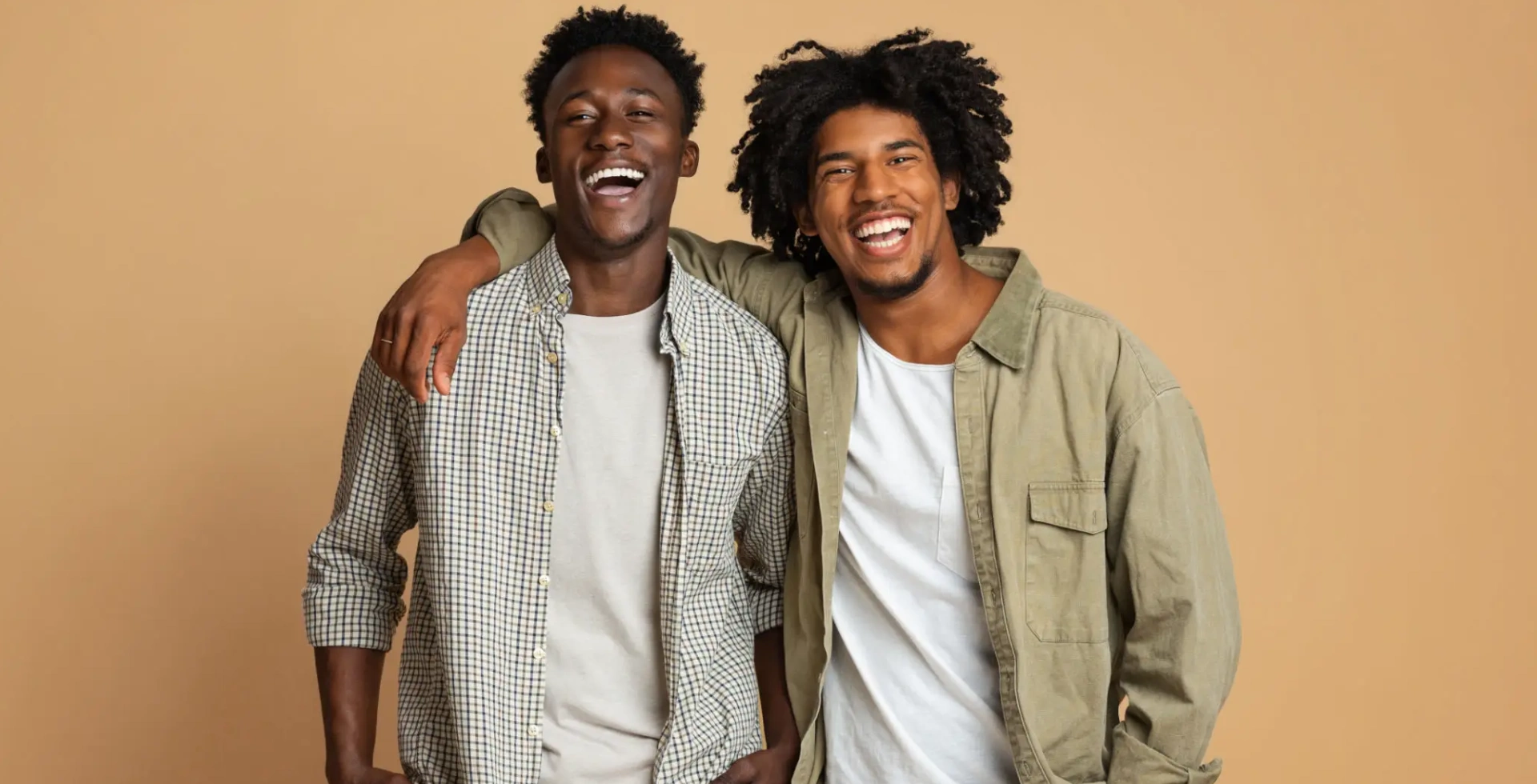 Two smiling men with arm around shoulder