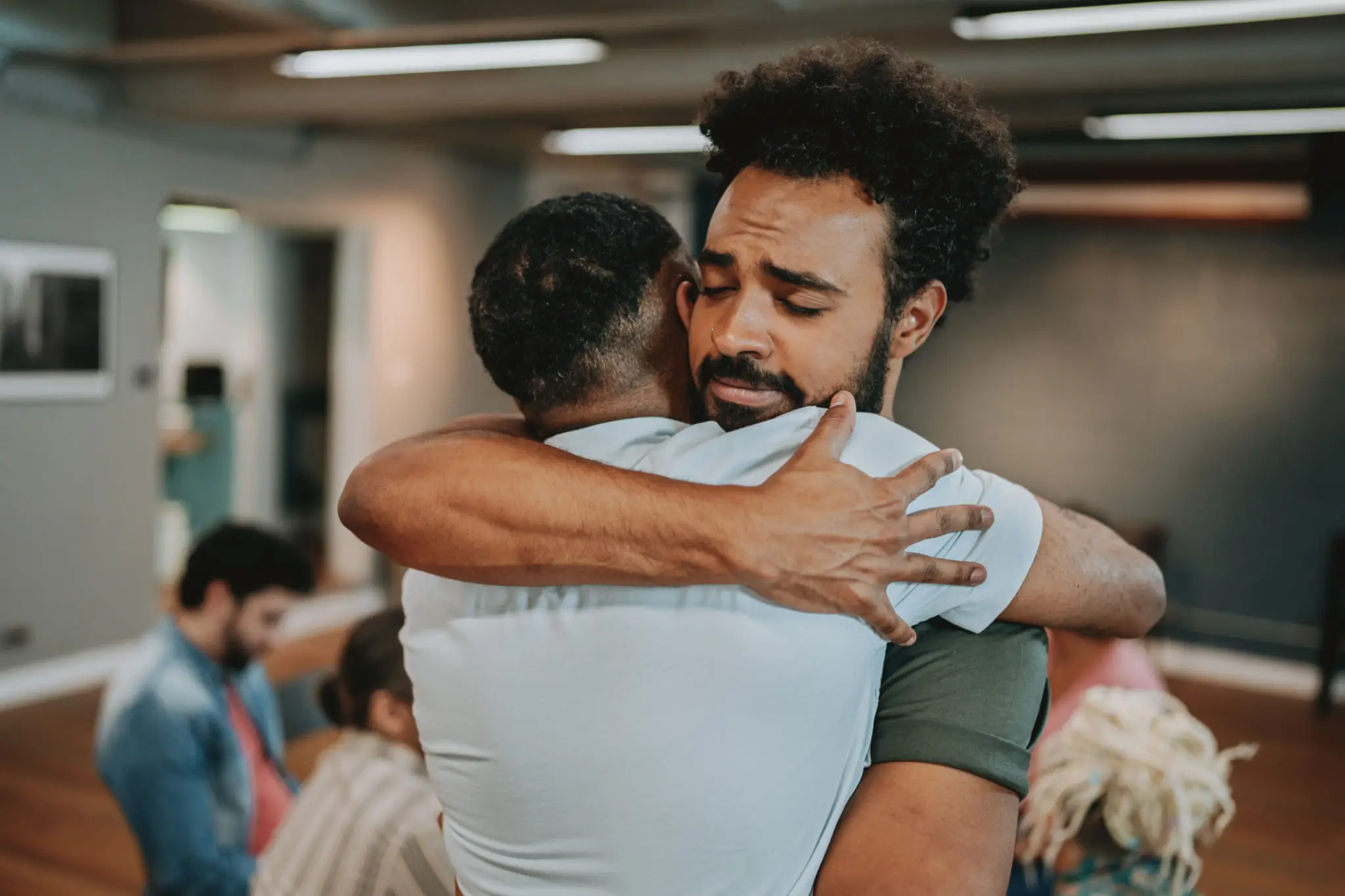 Two men embracing in emotional hug