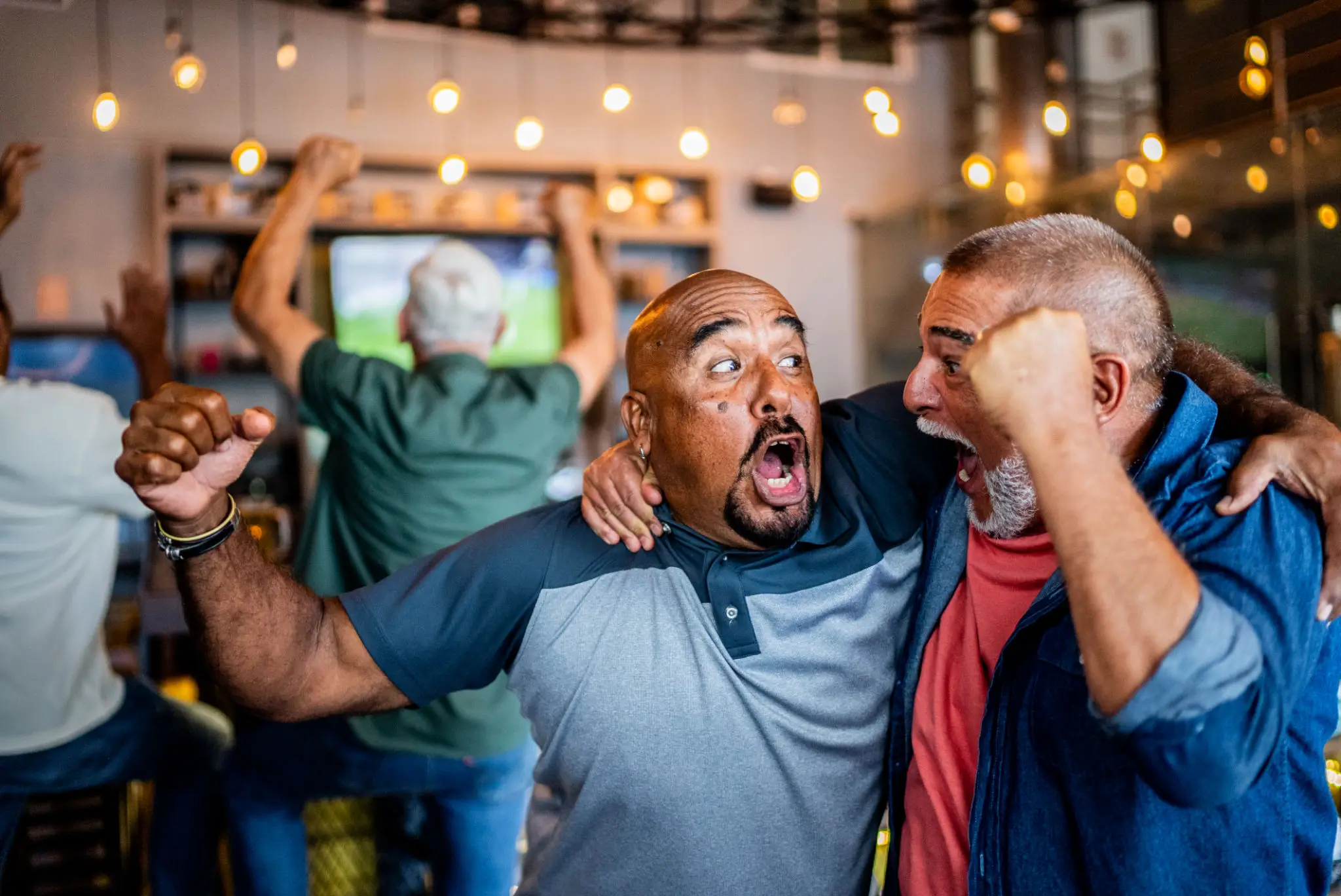 Two men celebrating at sports bar