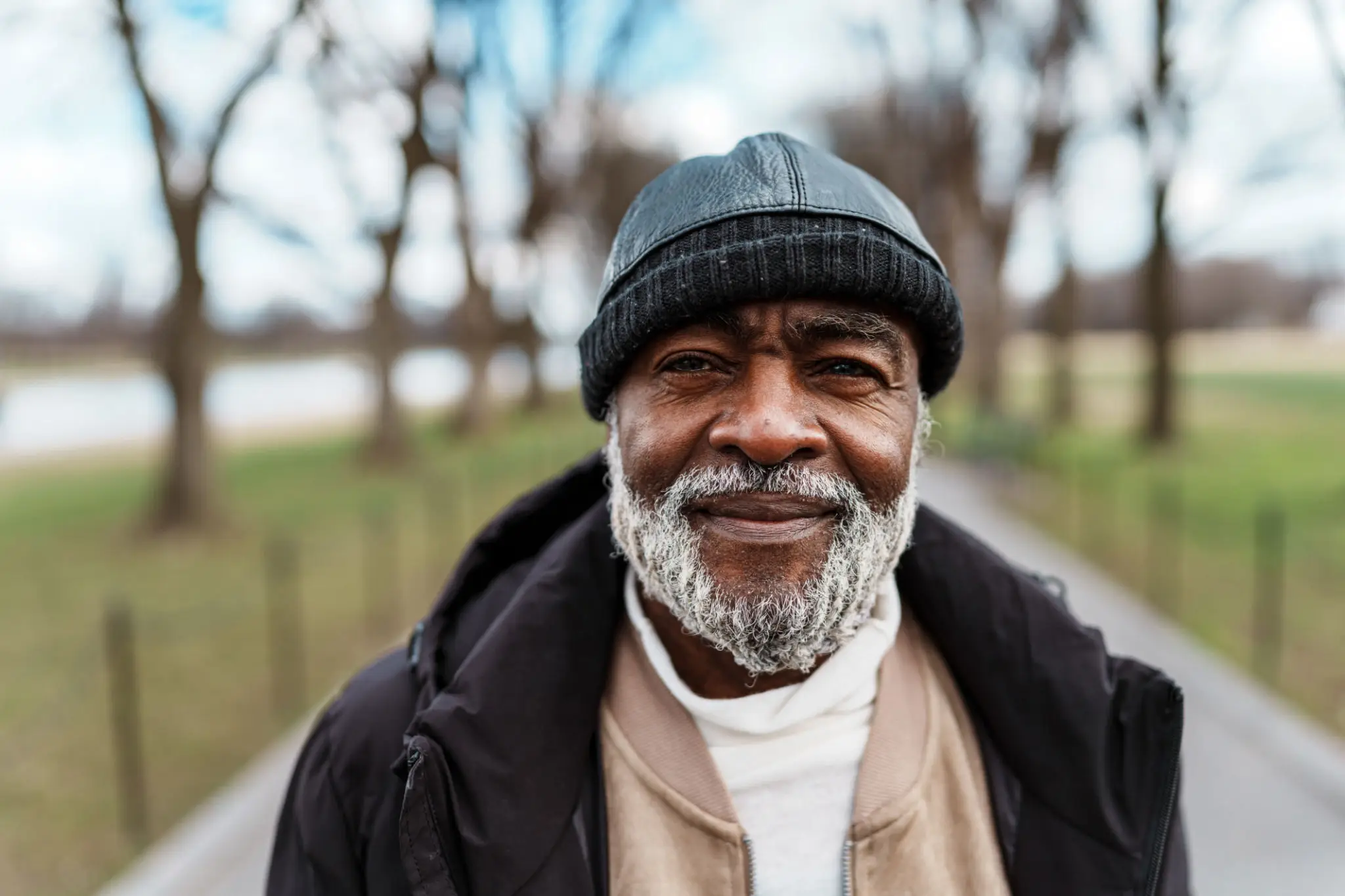 Smiling bearded man wearing knit hat