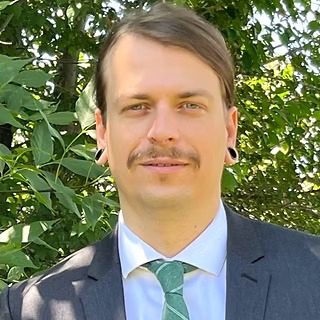 Outdoor portrait of man in suit, green tie