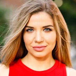 Blonde woman with blue eyes wearing red top
