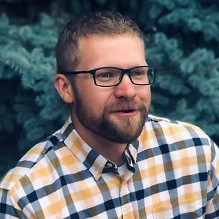 Person with glasses and plaid shirt