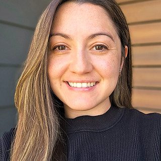 Smiling person with long brown hair