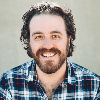 Smiling bearded man wearing plaid shirt