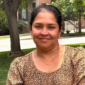 Smiling woman outdoors in patterned blouse