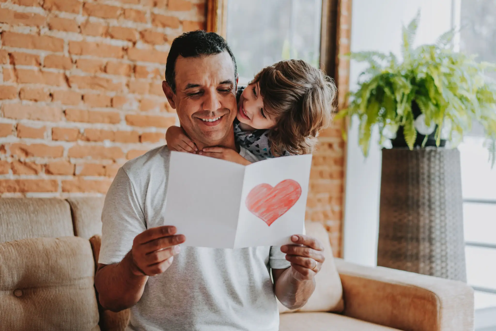 Father and child with handmade heart card