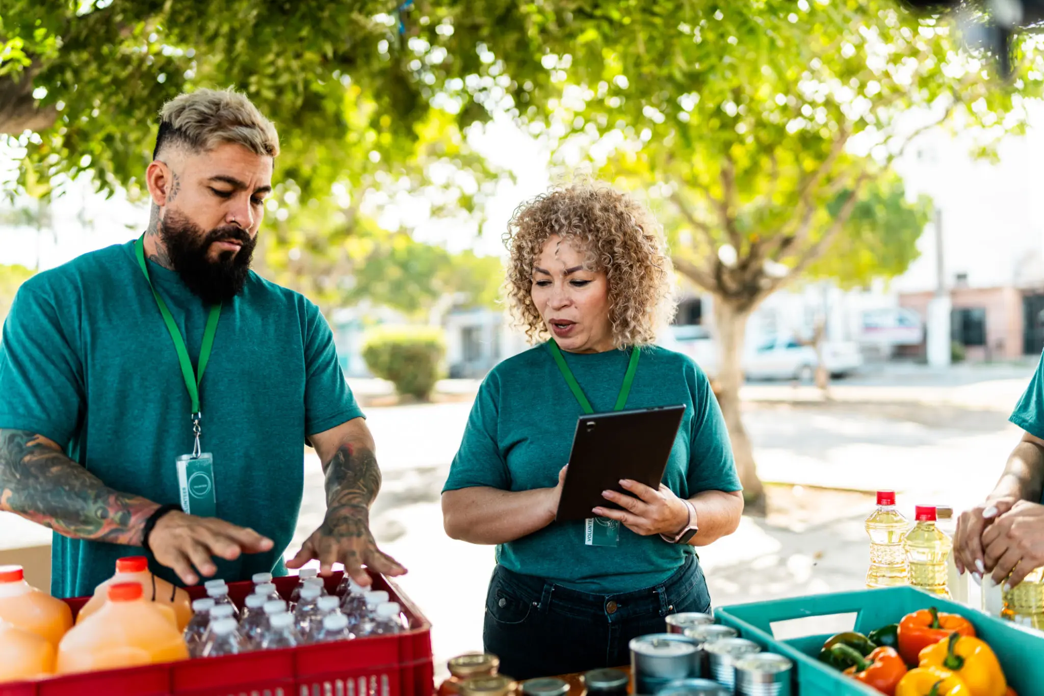 Volunteers sorting bottled water and groceries outdoors