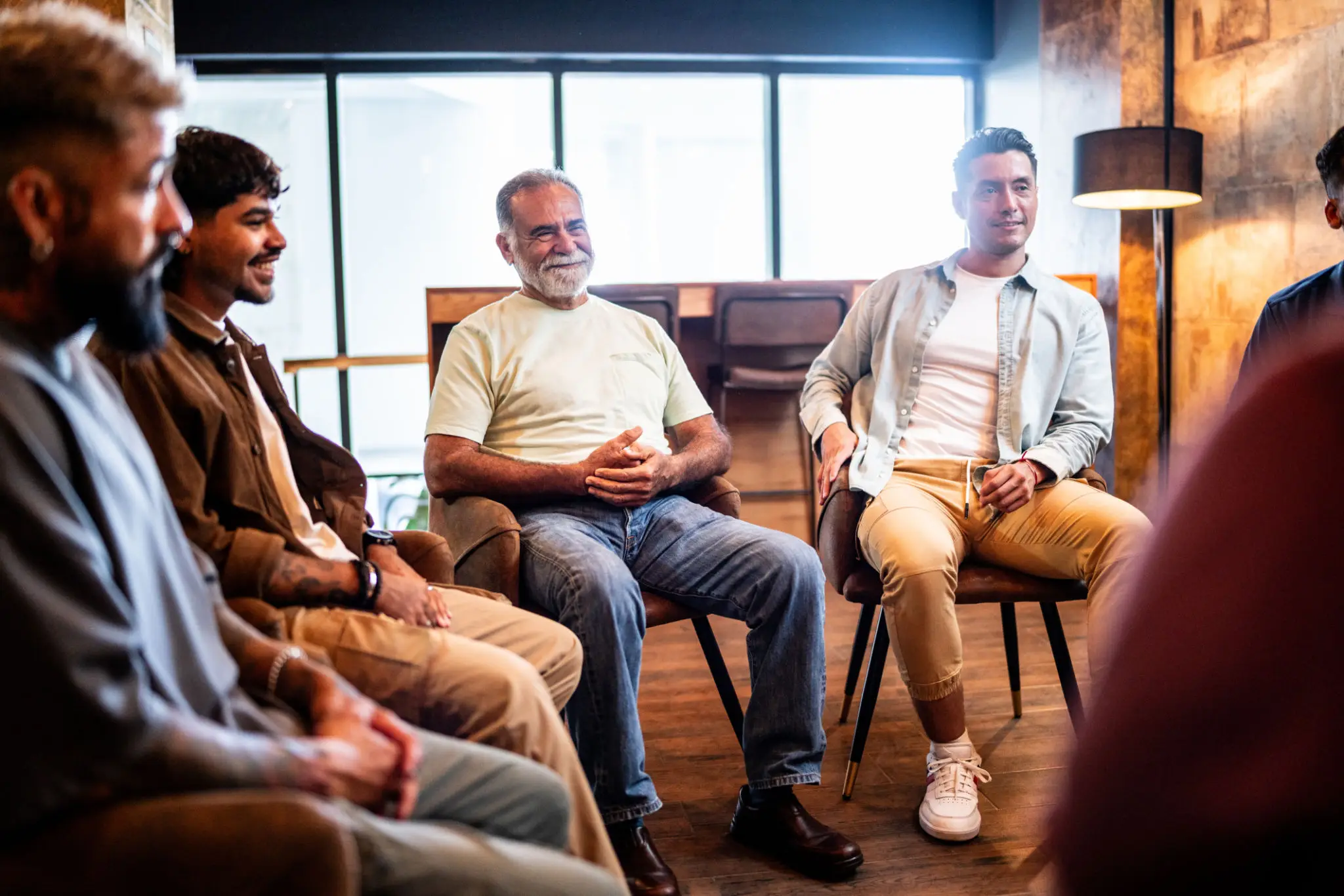 Men's support group meeting in casual circle