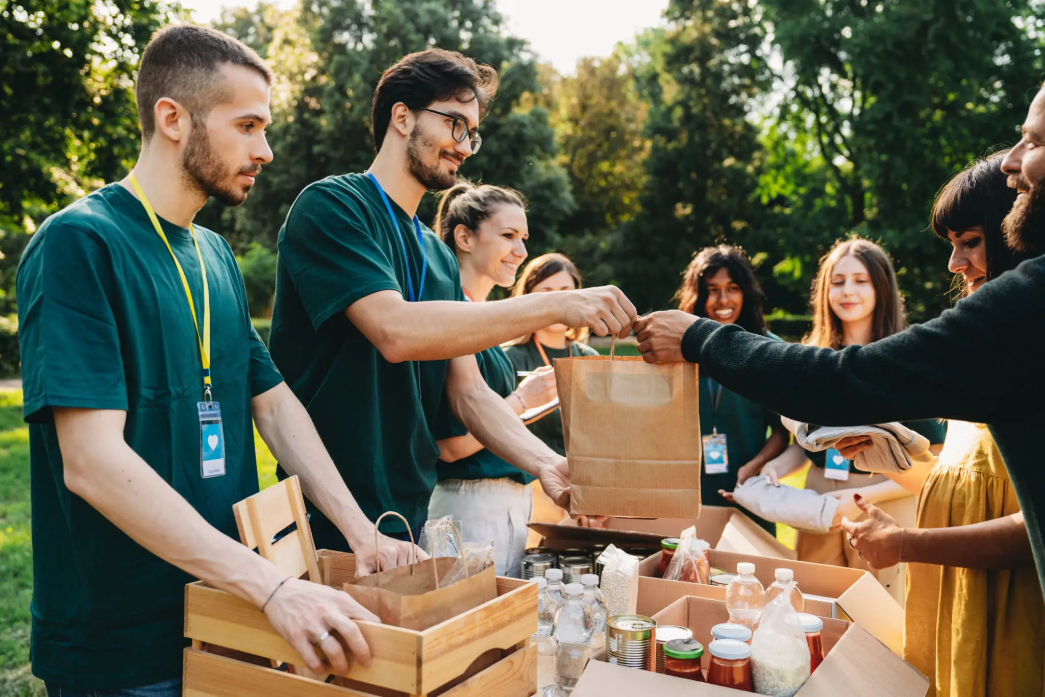 Volunteers distributing food bags at outdoor event
