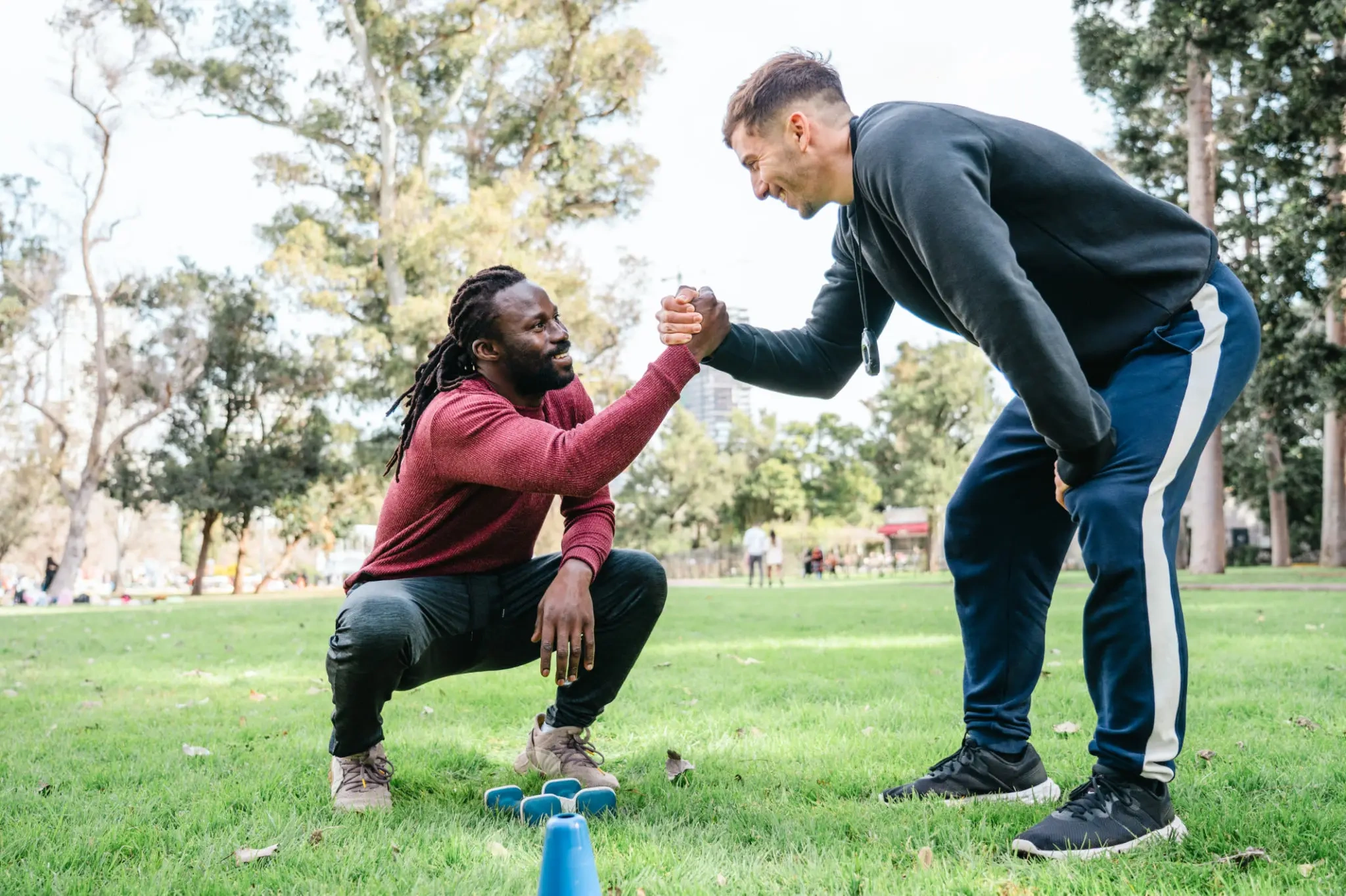Two men fist-bumping during outdoor workout