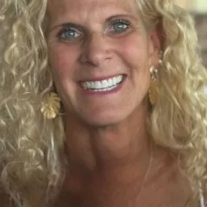 Smiling woman with curly blonde hair