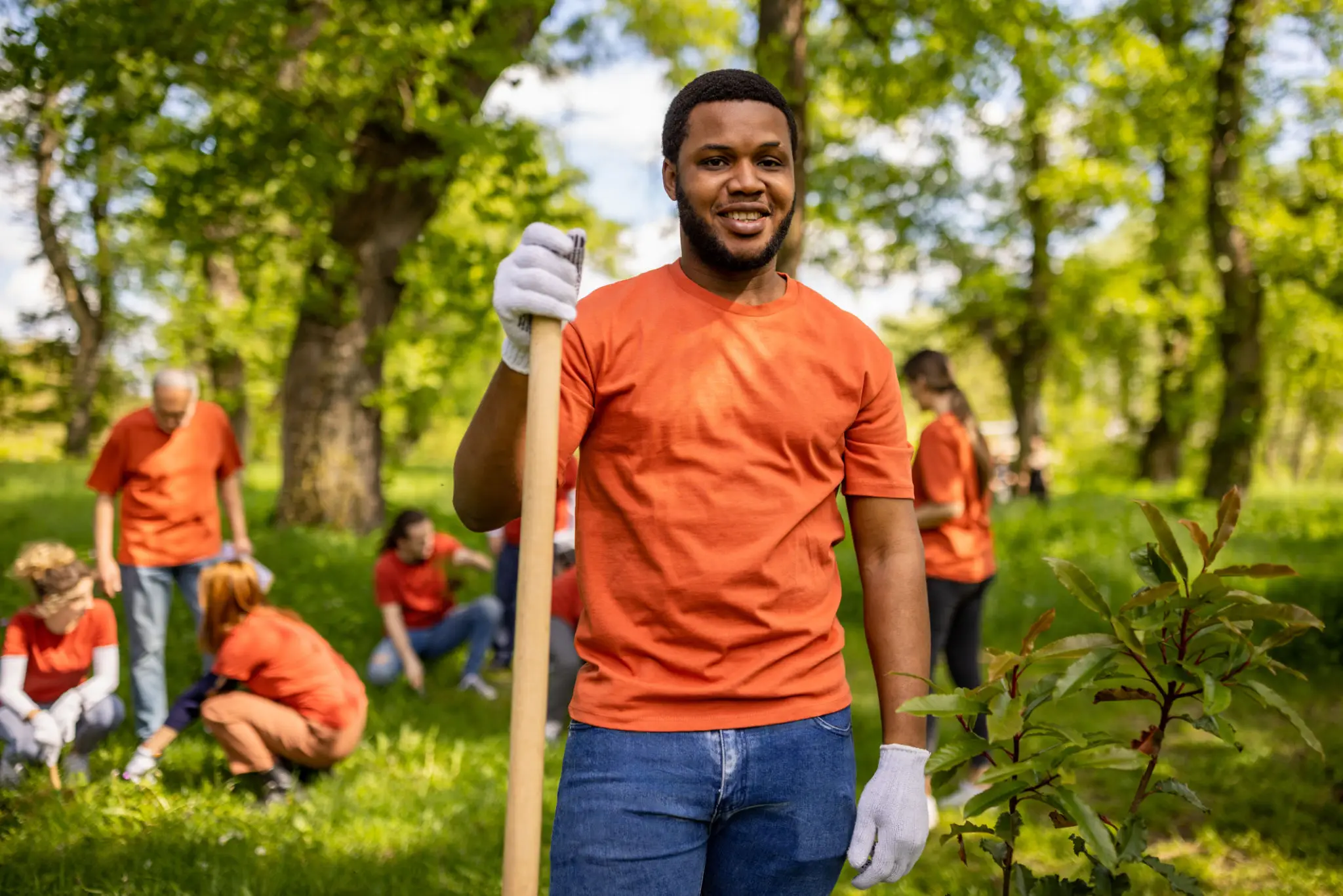 Volunteer holding shovel at outdoor tree planting