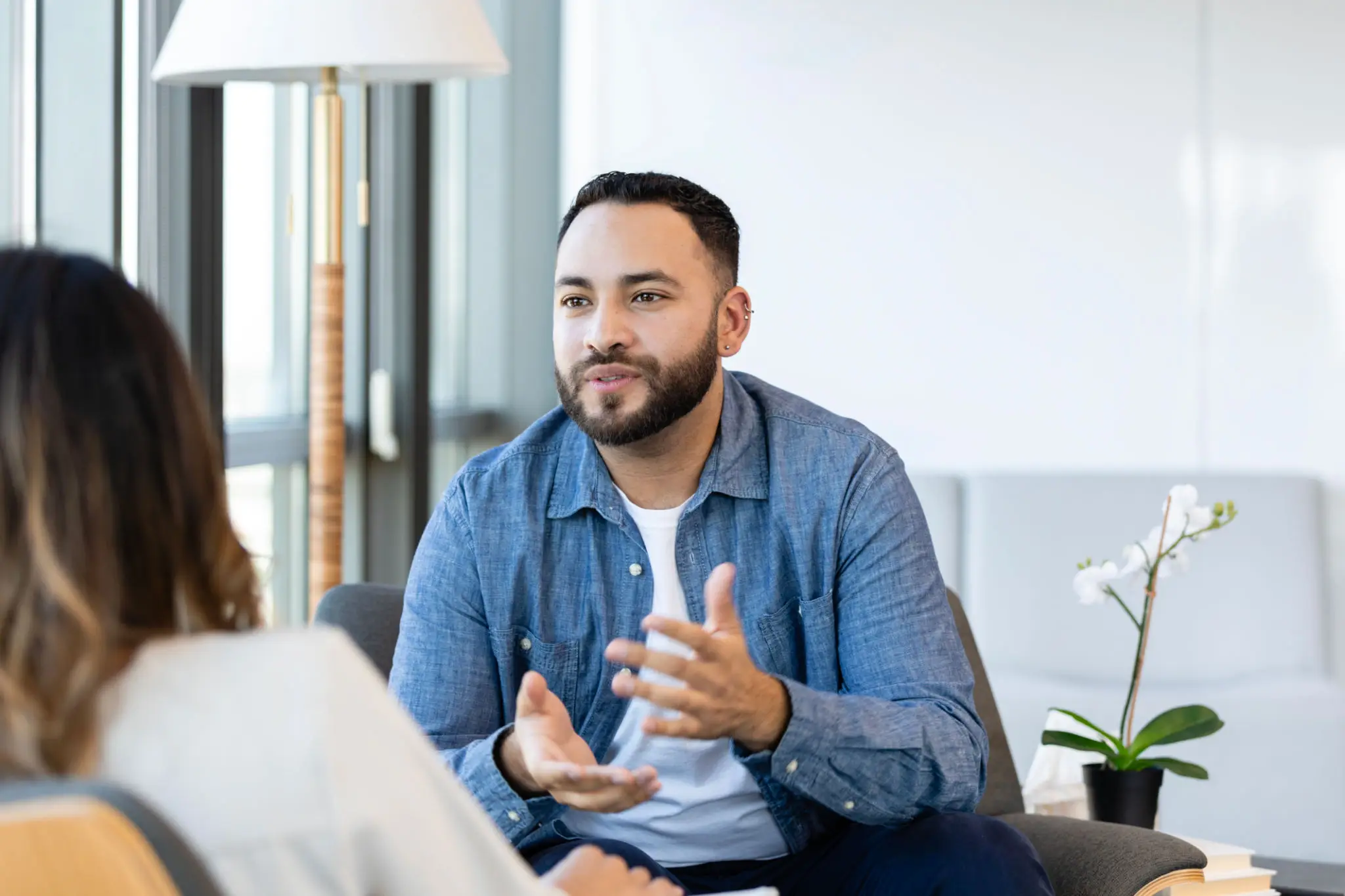 Man in blue shirt conversing with woman