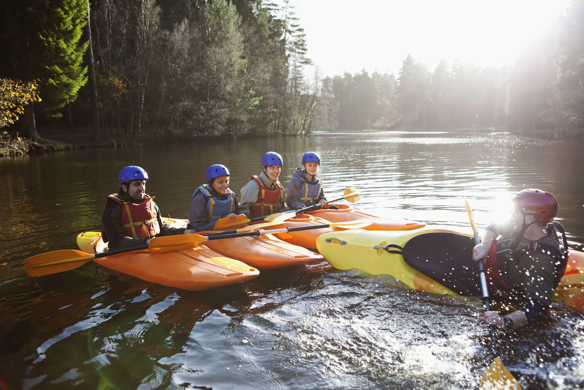 Group kayaking lesson on a calm lake